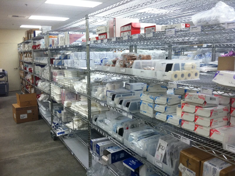 Chrome shelving with labelled medical supplies in a stockroom