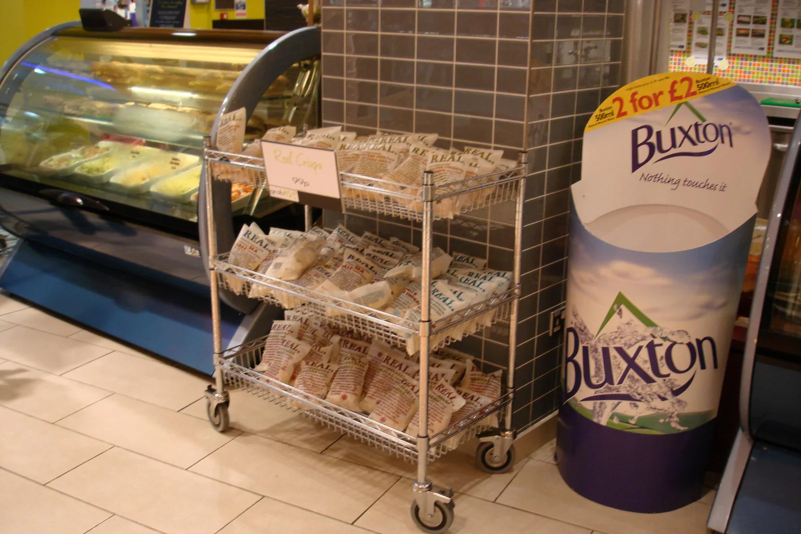 Compact mobile wire shelving beside a refrigerated counter
